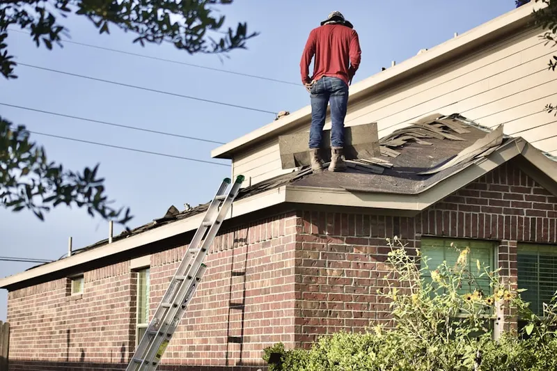 Professional roofer working on a residential roof in Desert Hills Estates